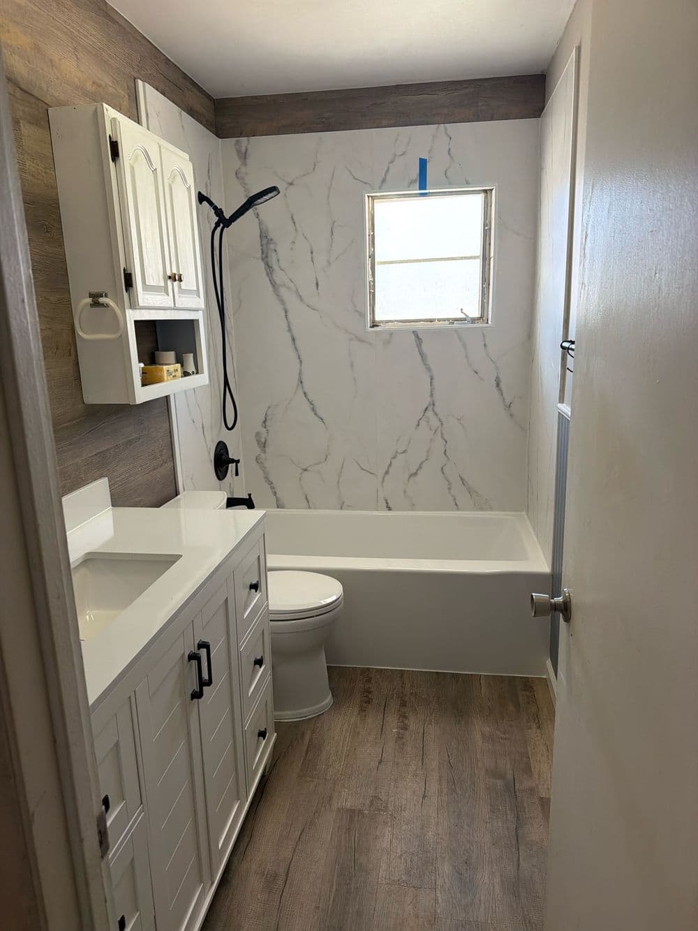 A finished bathroom with a new vanity and matte black fixtures