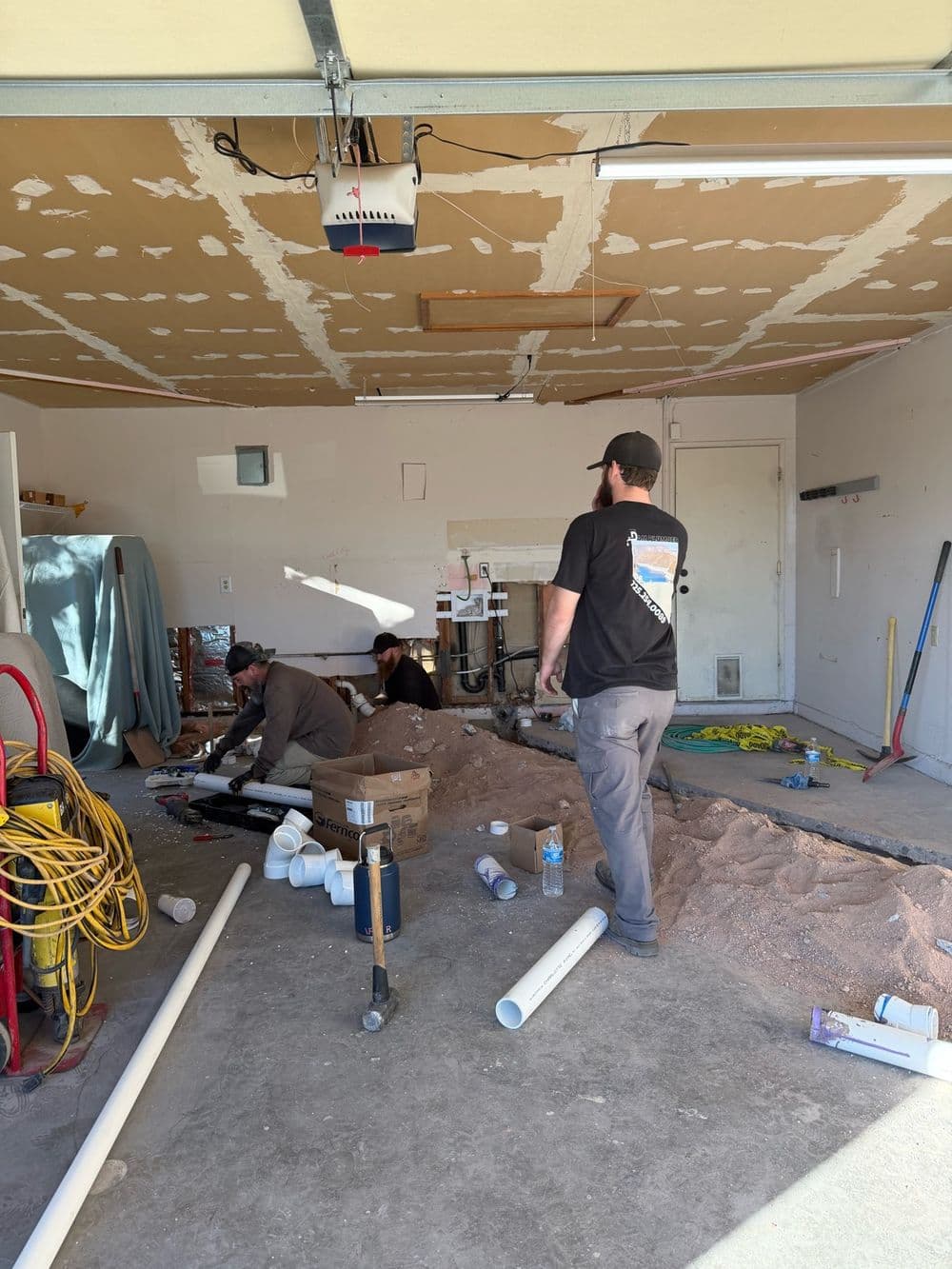 The Dam Plumber crew replacing a sewer line under a garage slab