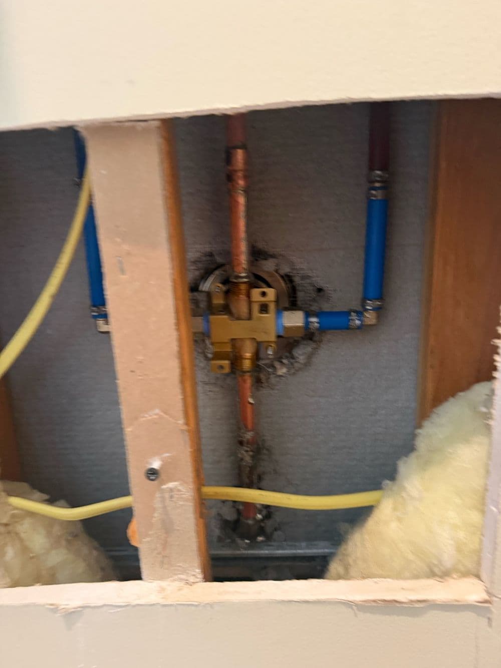 Shower valve rough-in with new copper and PEX lines in an open wall